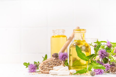 Milk Thistle supplies, powder and oil. Silybum marianum, natural organic wild flower superfood product - whole and grain seeds, pills, oil with fresh thistle flowersの写真素材