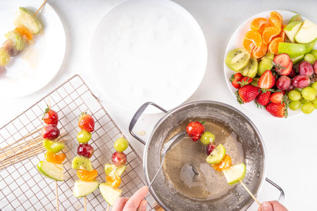 Traditional Chinese sweet street food recipe Tanghulu, fruit skewer on stick with crunchy sugar glaze, easy healthy dessert. Step by step preparation of Tanghulu with ingredients on table, top viewの写真素材