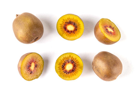 Red kiwi, Sweet bright red colored kiwi fruits, whole and sliced, on kitchen table copy spaceの写真素材