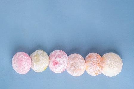 Various colorful fruit and berry mochi assortment. Traditional Japanese ice cream mochi, sweet dessert in rice dough, copy spaceの写真素材