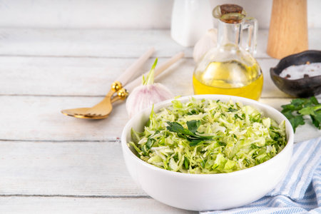 Spring cabbage salad, vegan healthy diet vegetable food, salad with spring cabbage, parsley, green onions, olive oil for dressingの写真素材
