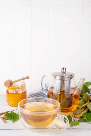 Natural organic birch tea. Herbal tea with leaves and blooming flowers with honey and pollen, organic hot detox healthy diet drinkの写真素材