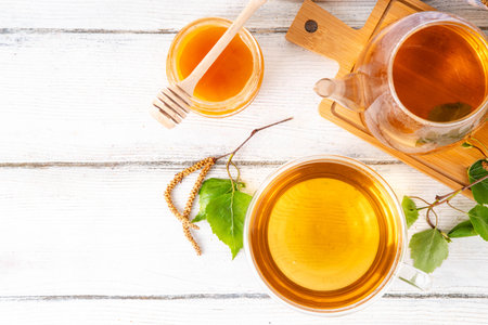 Natural organic birch tea. Herbal tea with leaves and blooming flowers with honey and pollen, organic hot detox healthy diet drinkの写真素材