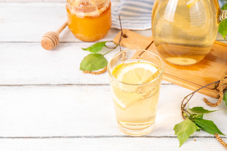 Cold birch tea, birch sap summer refreshment drink with honey and lemon. Infused detox beverageの写真素材