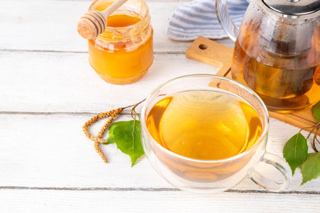 Natural organic birch tea. Herbal tea with leaves and blooming flowers with honey and pollen, organic hot detox healthy diet drinkの写真素材
