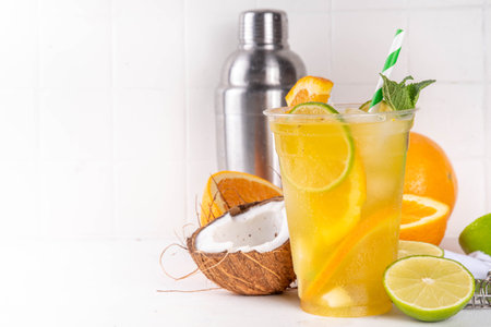 Orange coconut lemonade mojito drink, summer iced cocktail, mocktail with fresh fruit and juicesの写真素材