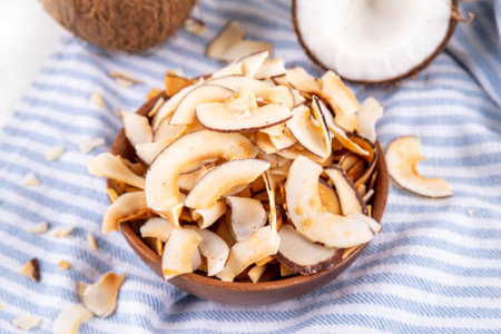 Homemade coconut chips, healthy organic coconut crackers, alternative snack for keto, diet lifestyle, with fresh coconut, copy spaceの写真素材