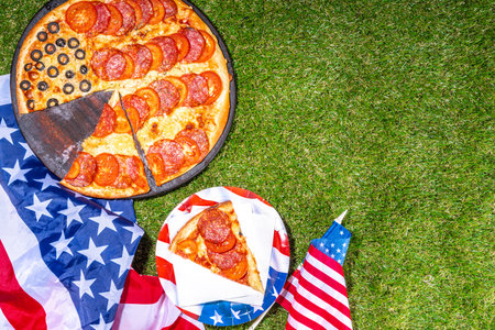 july 4th holiday party pizza, Fourth of July, Patriotic Independence day festive and picnic food. Pepperoni, tomato and black olive pizza with lot of mozzarella, in form of American flagの写真素材