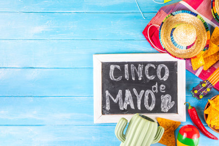 Cinco de Mayo holiday background with Mexican cactus decor, party sombrero hat, nachos chips, guitar, maracas. Cinco de Mayo holiday celebration greeting card, copy spaceの写真素材