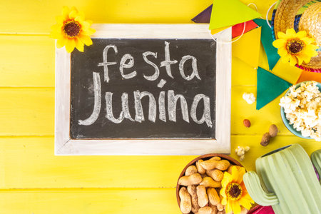 Festa Junina Brazil holiday greeting card background. Summer Brazilian harvest festival party background with traditional food - popcorn, peanuts, holiday hat, guitar, copy spaceの写真素材