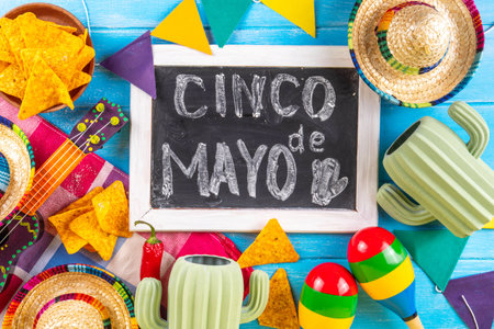 Cinco de Mayo holiday background with Mexican cactus decor, party sombrero hat, nachos chips, guitar, maracas. Cinco de Mayo holiday celebration greeting card, copy spaceの写真素材