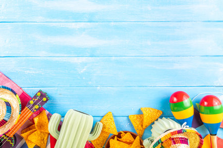 Cinco de Mayo holiday background with Mexican cactus decor, party sombrero hat, nachos chips, guitar, maracas. Cinco de Mayo holiday celebration greeting card, copy spaceの写真素材