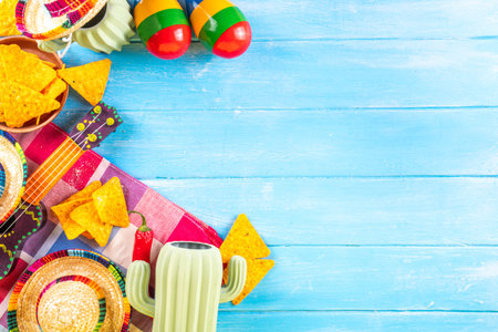 Cinco de Mayo holiday background with Mexican cactus decor, party sombrero hat, nachos chips, guitar, maracas. Cinco de Mayo holiday celebration greeting card, copy spaceの写真素材