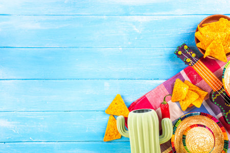Cinco de Mayo holiday background with Mexican cactus decor, party sombrero hat, nachos chips, guitar, maracas. Cinco de Mayo holiday celebration greeting card, copy spaceの写真素材