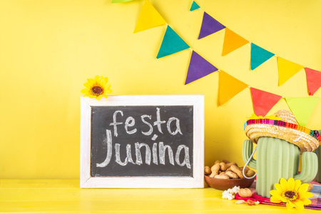 Festa Junina Brazil holiday greeting card background. Summer Brazilian harvest festival party background with traditional food - popcorn, peanuts, holiday hat, guitar, copy spaceの写真素材