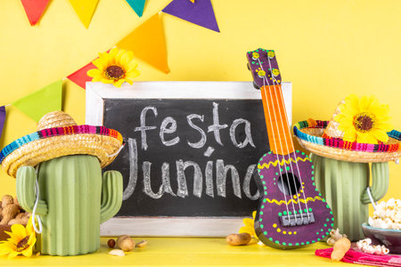 Festa Junina Brazil holiday greeting card background. Summer Brazilian harvest festival party background with traditional food - popcorn, peanuts, holiday hat, guitar, copy spaceの写真素材