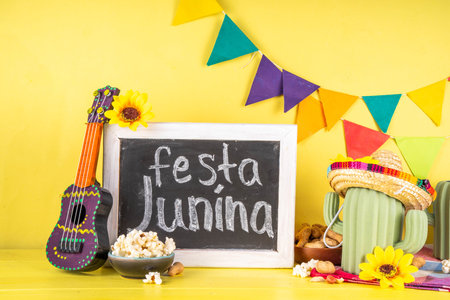 Festa Junina Brazil holiday greeting card background. Summer Brazilian harvest festival party background with traditional food - popcorn, peanuts, holiday hat, guitar, copy spaceの写真素材