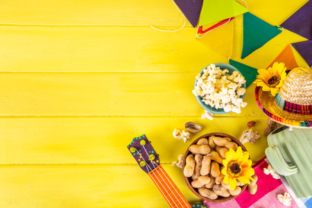 Festa Junina Brazil holiday greeting card background. Summer Brazilian harvest festival party background with traditional food - popcorn, peanuts, holiday hat, guitar, copy spaceの写真素材