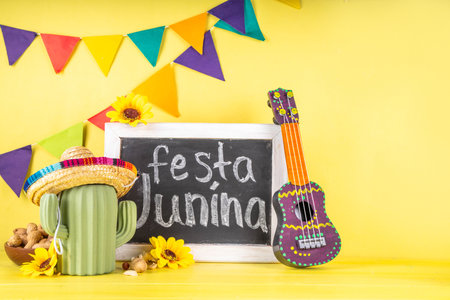 Festa Junina Brazil holiday greeting card background. Summer Brazilian harvest festival party background with traditional food - popcorn, peanuts, holiday hat, guitar, copy spaceの写真素材