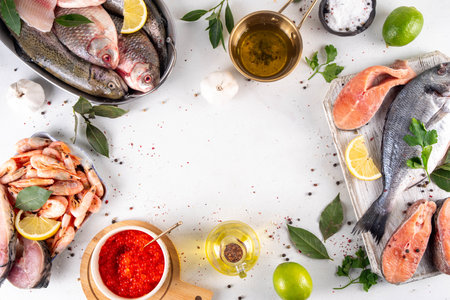 Variety raw fish and seafood background. Fresh fish, shrimps, mussels, caviar assortment flat lay, fish sale and market template,の写真素材