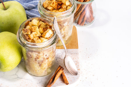 Apple pie mugcake in glass jar, Simple quick apple pie cinnamon cake recipe in microwave, on white background copy spaceの写真素材