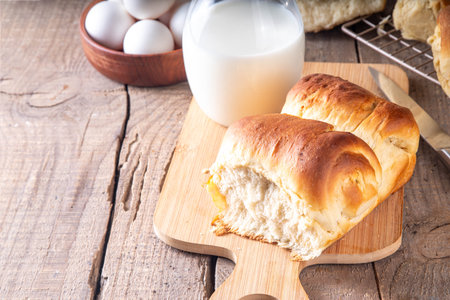 Japanese bread Shokupan, Hokkaido milk bread, or simply milk fluffy buns, on kitchen table, copy spaceの写真素材