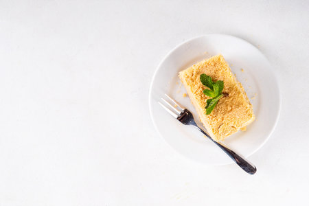 Homemade layered mille-feuille cake with vanilla creamy custard, tasty delicious puff pastry, on serving plates with forks, copy spaceの写真素材