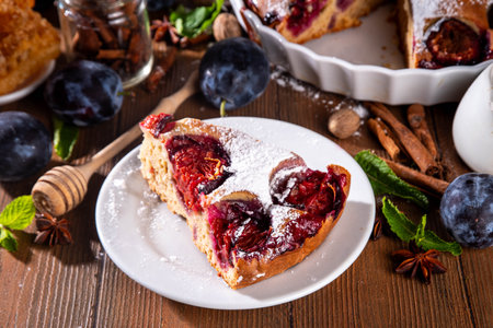 Autumn new york plum pie, tasty cinnamon spices plum torte cake on rustic cozy wooden background, copy spaceの写真素材