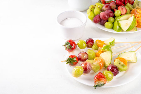 Traditional Chinese sweet street food recipe Tanghulu, fruit skewer on stick with crunchy sugar glaze, easy healthy dessert. Step by step preparation of Tanghulu with ingredients on table, top viewの写真素材