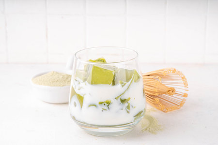 Matcha jelly latte, iced milky drink with green matcha tea jellatin cubes, trendy refreshing Iced non-caffeine healthy drinkの写真素材