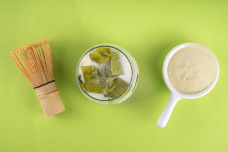 Matcha jelly latte, iced milky drink with green matcha tea jellatin cubes, trendy refreshing Iced non-caffeine healthy drinkの写真素材