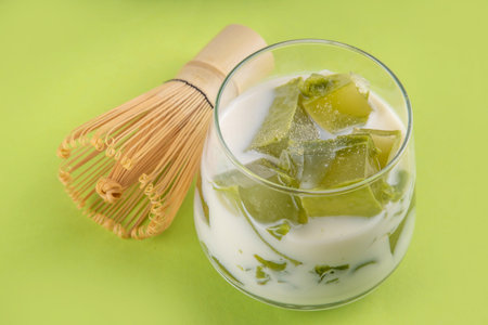 Matcha jelly latte, iced milky drink with green matcha tea jellatin cubes, trendy refreshing Iced non-caffeine healthy drinkの写真素材