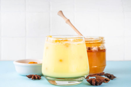 Iced golden milk drink, turmeric latte with ice cubes, Tasty summer cold beverage, alternative ayurvedic cocktailの写真素材