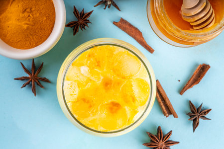 Iced golden milk drink, turmeric latte with ice cubes, Tasty summer cold beverage, alternative ayurvedic cocktailの写真素材
