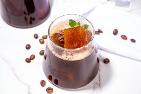 Cold Brew Coffee Espresso Carajillo Cocktail with frozen espresso ice cubes, strong black coffee, liqueur and Vodka, on white kitchen table background copy spaceの写真素材