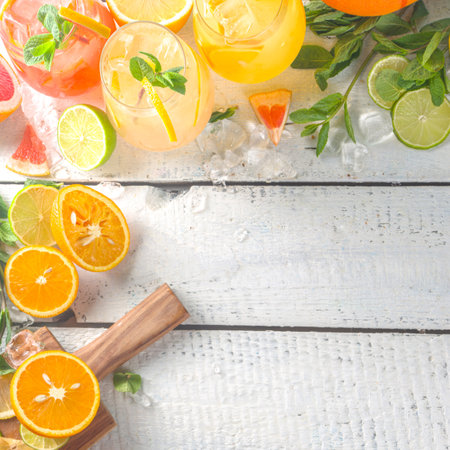 Summer cold drinks, fruit lemonade sangria cocktail, infused beverages with various citrus - orange, lemon, grapefruit, lime, with fresh fruits copy spaceの写真素材