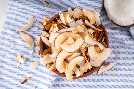 Homemade coconut chips, healthy organic coconut crackers, alternative snack for keto, diet lifestyle, with fresh coconut, copy spaceの写真素材