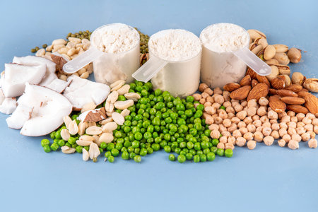 Various source vegan protein powders. Vegetarian plant based protein shakes powder and ingredient for it - green peas, soybeans, almonds, pistachios, peanuts, coconut, legumes.の写真素材