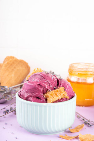 Sweet lavender honey ice cream, creamy rich taste sorbet gelato with lavender flower and syrup, honey and honeycomb. Unusual artisanal lavandula ice cream recipe ideaの写真素材