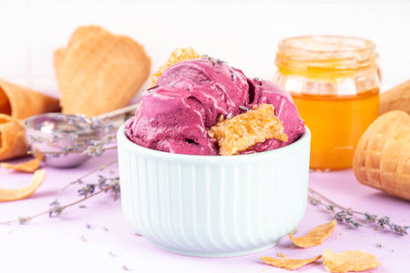 Sweet lavender honey ice cream, creamy rich taste sorbet gelato with lavender flower and syrup, honey and honeycomb. Unusual artisanal lavandula ice cream recipe ideaの写真素材