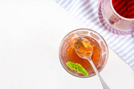 Black tea trendy asian dessert, diet non calorie sweet tea agar or gelatine jelly, in portioned glass, white table background copy spaceの写真素材