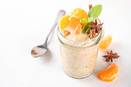 Tangerine creamsicle Overnight Oats, sweet breakfast oatmeal with creamsicle and fresh tangerine slices, spices and orange peelの写真素材