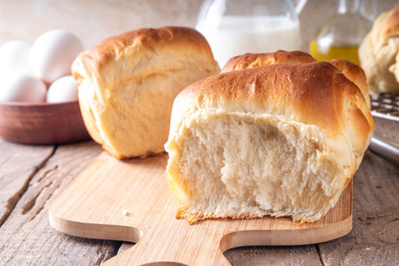 Japanese bread Shokupan, Hokkaido milk bread, or simply milk fluffy buns, on kitchen table, copy spaceの写真素材