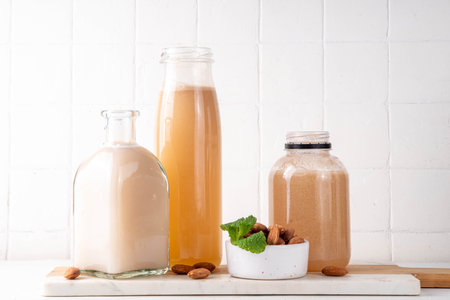 Homemade almond Orgeat Syrup in different bottles, almonds, water, sugar, and orange flower water syrup for making sweet cocktailsの写真素材