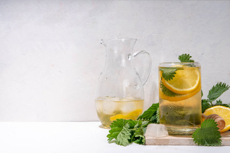 Nettle Tea cold plant drink, iced tea or lemonade. Organic natural herbal tea without caffeine, made with organic raw nettle leaves. Alternative herbal medicine. Stinging nettles, urtica.の写真素材