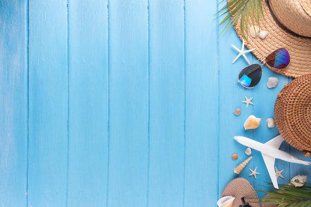Summer holiday and vacation background with straw hat, bag, flip flops, palm leaves, sunglasses, camera, seashells and ocean starfish. Beach and tropical summer vacation background, top view copy spaceの写真素材