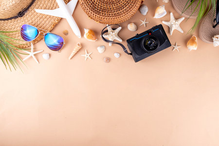 Summer holiday and vacation background with straw hat, bag, flip flops, palm leaves, sunglasses, camera, seashells and ocean starfish. Beach and tropical summer vacation background, top view copy spaceの写真素材