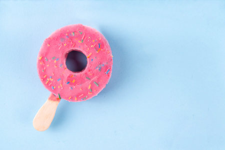 Summer vacation and holidays concept with ice cream in the form of pink donut lifebuoy, with the...