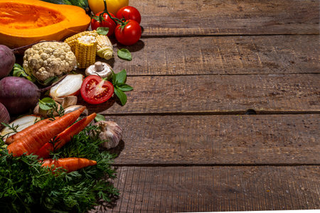 Autumn vegetables cooking background. Organic fall harvest farm vegetables, mushrooms. Various vegetarian ingredients set for cooking dinner on wooden kitchen background, top view copy spaceの写真素材