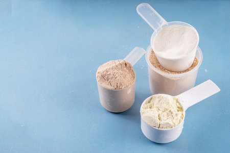 Different protein flavors in plastic scoops. Protein powder shakes for weight loss, set every day protein goals, sport and fitness, healthy lifestyleの写真素材